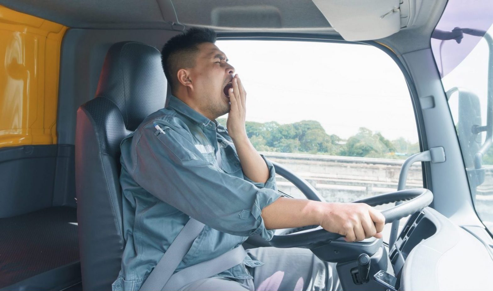 Truck driver yawning for fatigue when needing help from Truck Accident Injury Lawyer Norfolk.