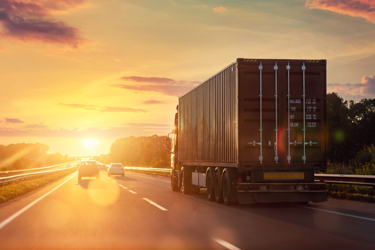 How is Liability Determined When Multiple Parties are Involved in a Truck Accident? A semi truck drives on a highway at sunset alongside several cars, when involved in highway accident with big truck meet with Truck accident attorney Hampton